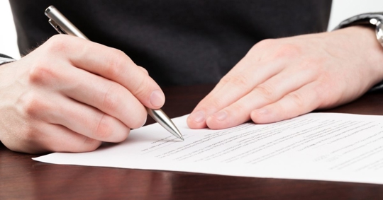 person signing a document